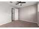 Neutral bedroom with carpet flooring, ceiling fan, and closet access at 23020 E Excelsior Ave, Queen Creek, AZ 85142