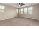 Light-filled bedroom with a ceiling fan and several windows at 23020 E Excelsior Ave, Queen Creek, AZ 85142