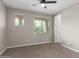 Spacious neutral bedroom with bright windows and ceiling fan at 23020 E Excelsior Ave, Queen Creek, AZ 85142