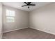 Neutral bedroom with carpet flooring, bright window, and ceiling fan at 23020 E Excelsior Ave, Queen Creek, AZ 85142