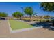 Well-maintained bocce ball court with nearby seating and lush landscaping for community enjoyment at 23020 E Excelsior Ave, Queen Creek, AZ 85142