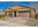 Charming home with a two car garage, stone accents, and a well-maintained, brick driveway at 23020 E Excelsior Ave, Queen Creek, AZ 85142