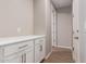 Bright hallway with white cabinets and wood flooring at 23020 E Excelsior Ave, Queen Creek, AZ 85142