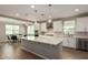 Bright open-concept kitchen with an island, stainless steel appliances, and adjacent dining area at 23020 E Excelsior Ave, Queen Creek, AZ 85142