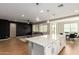 Island kitchen with a dining and living area beyond at 23020 E Excelsior Ave, Queen Creek, AZ 85142