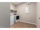 Bright laundry room with new appliances and tile flooring at 23020 E Excelsior Ave, Queen Creek, AZ 85142