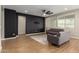 Bright living room featuring modern accent wall and stylish tile flooring at 23020 E Excelsior Ave, Queen Creek, AZ 85142