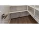 Walk-in pantry with wood flooring, and white shelving for organization and storage at 23020 E Excelsior Ave, Queen Creek, AZ 85142