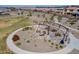 Aerial shot of a community park featuring a fire pit, benches, and unique desert landscaping at 23020 E Excelsior Ave, Queen Creek, AZ 85142