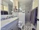 Updated bathroom featuring a tiled shower, modern vanity, and stylish decor at 2329 E Juanita Ave, Mesa, AZ 85204