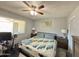 Comfortable bedroom with ceiling fan, carpeted floor, and a large window for natural light at 2329 E Juanita Ave, Mesa, AZ 85204