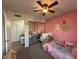 Pink bedroom featuring a mirror closet, twin bed and a ceiling fan at 2329 E Juanita Ave, Mesa, AZ 85204