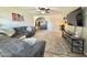Inviting living room with a comfortable couch, plush rug, and a modern entertainment center at 2329 E Juanita Ave, Mesa, AZ 85204