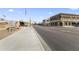 View of downtown Gilbert with charming brick buildings, shops, and US flags along wide avenue at 2329 E Juanita Ave, Mesa, AZ 85204