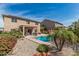 Expansive backyard with a pool, covered patio, lush landscaping, and solar panels for energy efficiency at 26011 W Tonopah Dr, Buckeye, AZ 85396