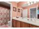 A full bathroom featuring a single sink vanity, and shower with patterned curtain at 26011 W Tonopah Dr, Buckeye, AZ 85396