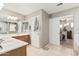 Bathroom featuring a double sink vanity, tile flooring, and a door leading to the closet at 26011 W Tonopah Dr, Buckeye, AZ 85396