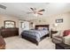 The primary bedroom includes a ceiling fan and an en-suite bathroom with double sinks and a large walk-in shower at 26011 W Tonopah Dr, Buckeye, AZ 85396