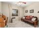Bedroom features a desk, futon, window, and neutral carpet at 26011 W Tonopah Dr, Buckeye, AZ 85396