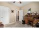 A bedroom with a desk, door, carpet and plenty of sunlight at 26011 W Tonopah Dr, Buckeye, AZ 85396