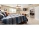 Comfortable bedroom with neutral carpet, a mounted TV, and a doorway leading to the Gathering room at 26011 W Tonopah Dr, Buckeye, AZ 85396