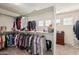 Walk-in closet with ample hanging space, shelving, and built in drawer storage at 26011 W Tonopah Dr, Buckeye, AZ 85396