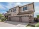 Side view of a two-story home with a three-car garage and landscaped yard at 26011 W Tonopah Dr, Buckeye, AZ 85396
