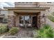 Inviting front porch with seating area, stone columns, and desert landscaping at 26011 W Tonopah Dr, Buckeye, AZ 85396