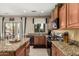 Well-equipped kitchen with granite countertops, black appliances, and outdoor access at 26011 W Tonopah Dr, Buckeye, AZ 85396