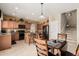 Charming eat-in kitchen features tile floor, dark appliances, and staircase access at 26011 W Tonopah Dr, Buckeye, AZ 85396
