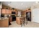 Well-equipped kitchen with granite countertops, wood cabinetry, and stainless appliances at 26011 W Tonopah Dr, Buckeye, AZ 85396