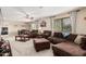 Living room featuring a ceiling fan, large sofas, windows, and dining table at 26011 W Tonopah Dr, Buckeye, AZ 85396