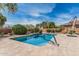 Backyard features a beautiful in-ground pool, patio, and lush landscaping at 26011 W Tonopah Dr, Buckeye, AZ 85396
