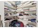 Organized walk-in closet with shelves for linens, pillows, and storage at 26011 W Tonopah Dr, Buckeye, AZ 85396
