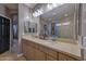 Bathroom featuring a double sink vanity and glass-enclosed shower at 27173 N 86Th Ave, Peoria, AZ 85383