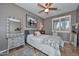 Bedroom with a London image, white floral bedspread, tiled floors and ceiling fan at 27173 N 86Th Ave, Peoria, AZ 85383