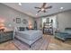 Bedroom features a ceiling fan, tiled floors and a decorative rug at 27173 N 86Th Ave, Peoria, AZ 85383
