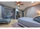 Bedroom with tiled floors, TV, curtains, and a ceiling fan at 27173 N 86Th Ave, Peoria, AZ 85383