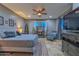 Bedroom with ceiling fan and tiled floors with a mounted TV at 27173 N 86Th Ave, Peoria, AZ 85383