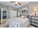 Bedroom with a London image, white floral bedspread, tiled floors and ceiling fan at 27173 N 86Th Ave, Peoria, AZ 85383