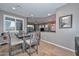 Dining area featuring a wooden dining table and seating for four, with a view into the living room at 27173 N 86Th Ave, Peoria, AZ 85383