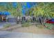 Charming single Gathering home with lush desert landscaping including trees, bushes and gravel ground cover at 27173 N 86Th Ave, Peoria, AZ 85383
