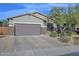 Beautiful single Gathering home featuring a two car garage, desert landscaping, and stone veneer accents at 27173 N 86Th Ave, Peoria, AZ 85383