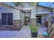 Inviting front porch featuring stone columns, desert landscaping and a decorative iron security door at 27173 N 86Th Ave, Peoria, AZ 85383