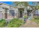Charming front porch featuring desert landscaping, stone columns, and decorative iron door at 27173 N 86Th Ave, Peoria, AZ 85383