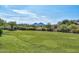 Beautiful expansive green space surrounded by desert landscaping and mountains in the distance at 27173 N 86Th Ave, Peoria, AZ 85383