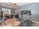 Home gym featuring a treadmill, exercise bike, and tiled floors at 27173 N 86Th Ave, Peoria, AZ 85383