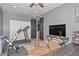 Home gym featuring a treadmill, exercise bike, TV, and tiled floors at 27173 N 86Th Ave, Peoria, AZ 85383