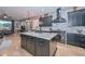 Gourmet kitchen featuring stainless steel appliances, a large center island with countertop seating, and stylish fixtures at 27173 N 86Th Ave, Peoria, AZ 85383
