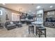 Open concept living room with a kitchen, sofas, bar seating, and decor at 27173 N 86Th Ave, Peoria, AZ 85383